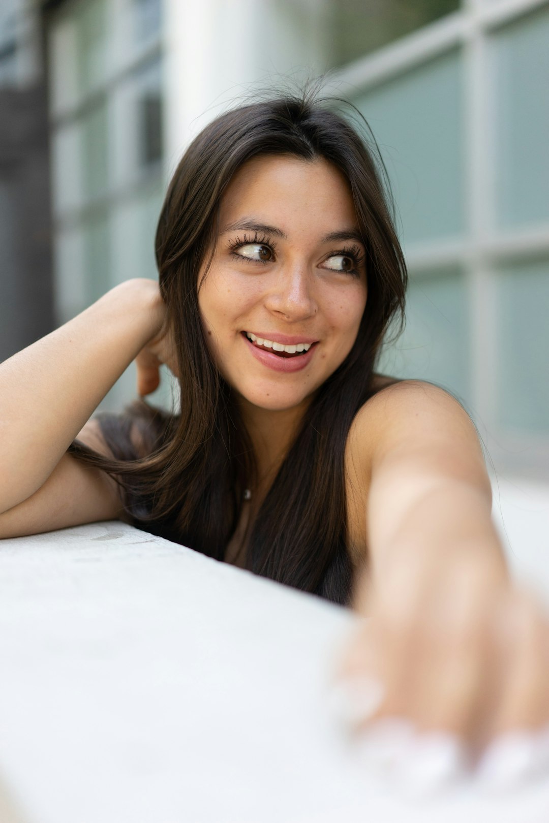 woman in white tank top lying on bed