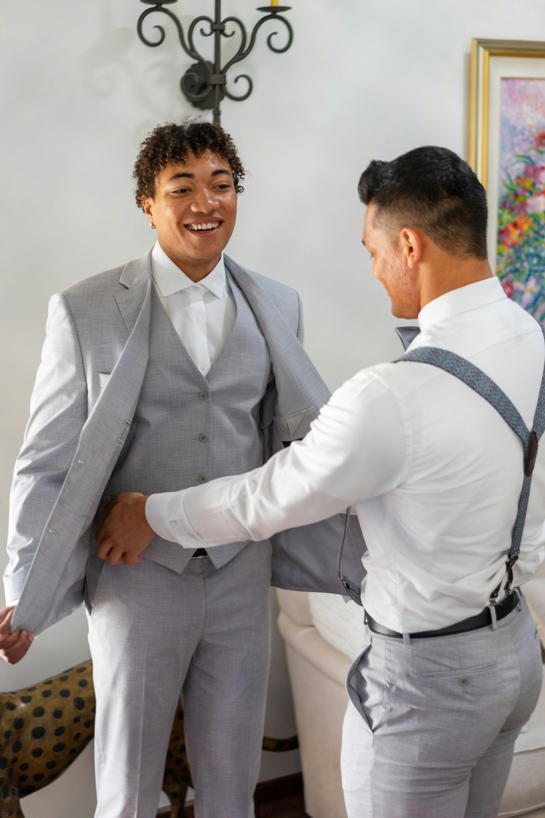 man in white dress shirt and gray vest standing beside woman in white dress shirt