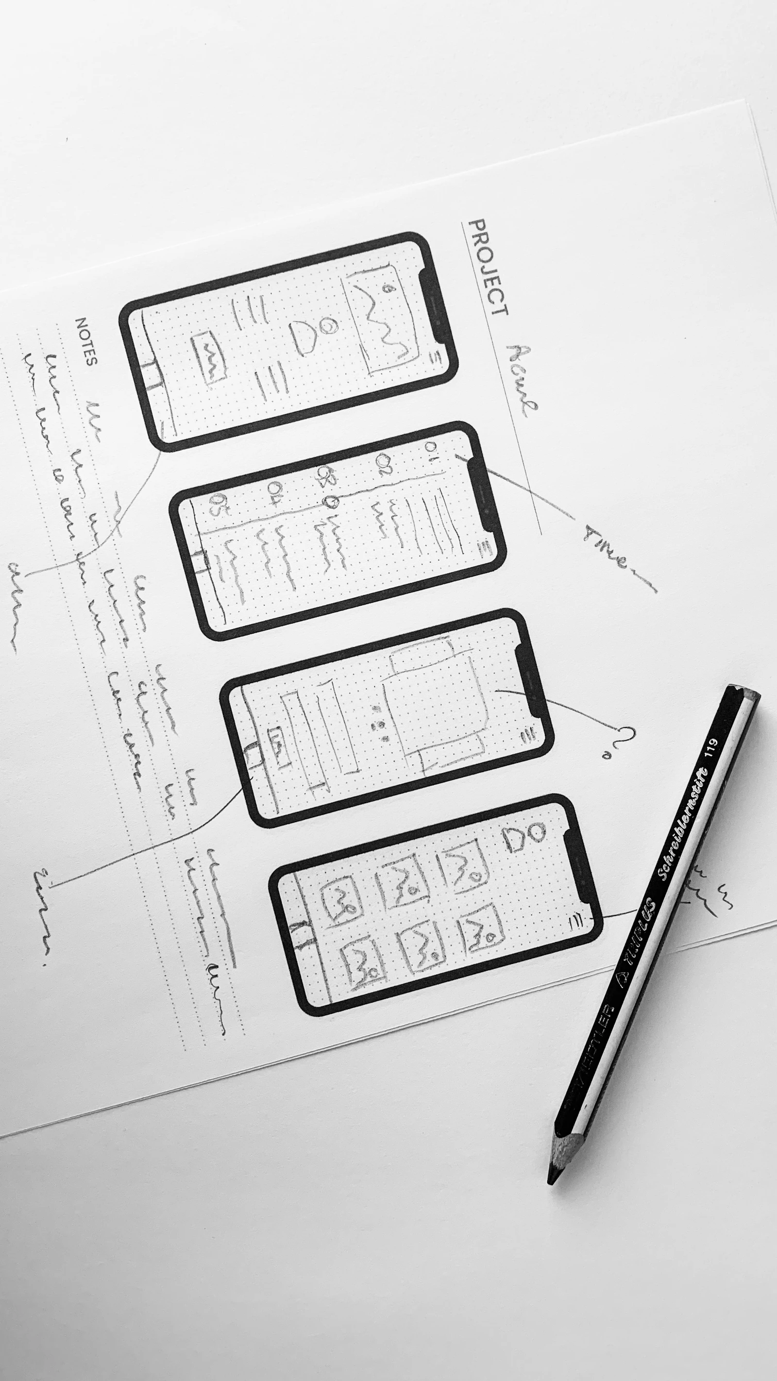 Hand-drawn mobile app wireframes on paper