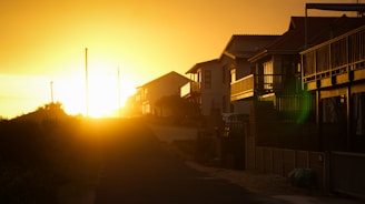 silhouette of houses during sunset