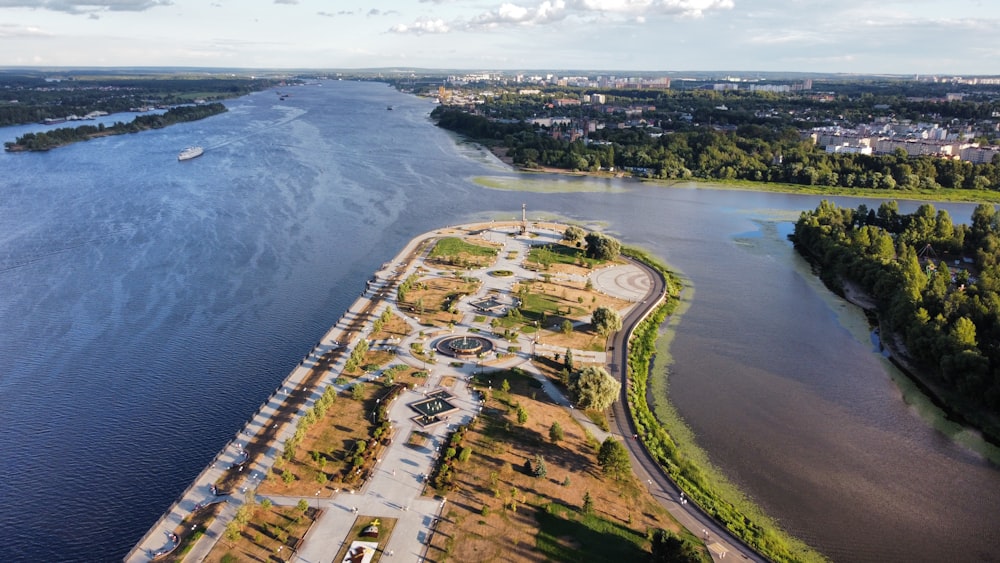 aerial view of green grass field near body of water during daytime