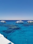 white yacht on blue sea under blue sky during daytime