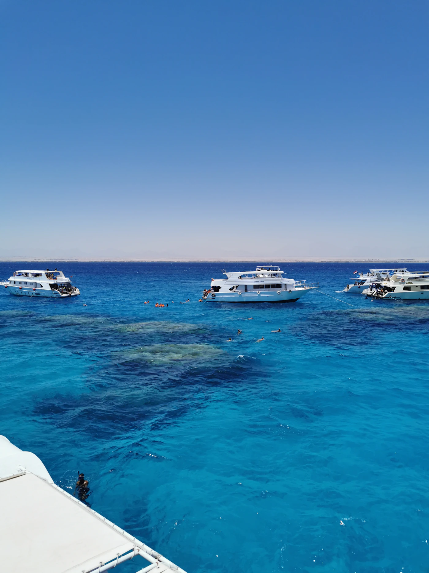 White yacht surrounded by clear blue sea