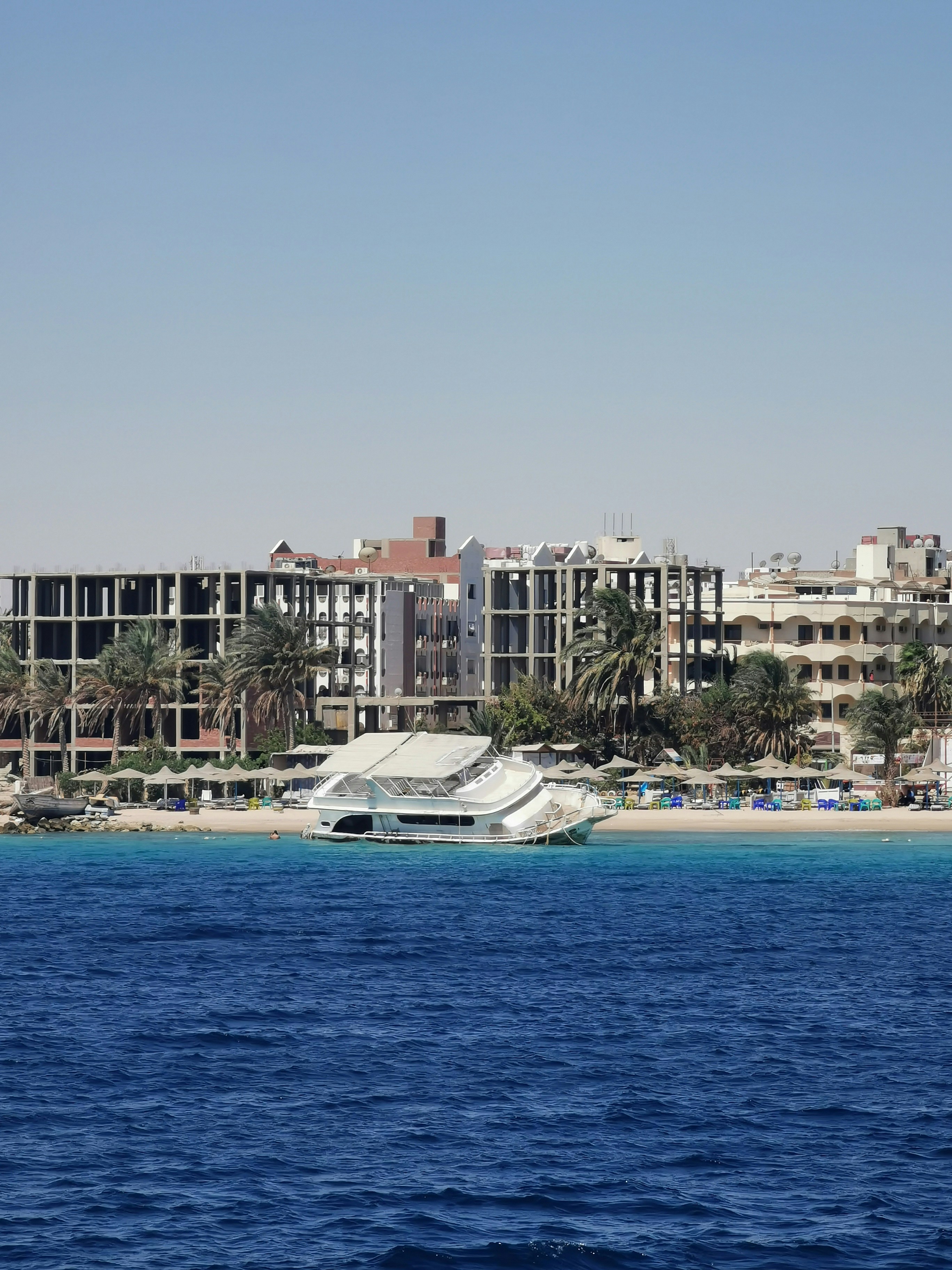 white and brown concrete building near body of water during daytime