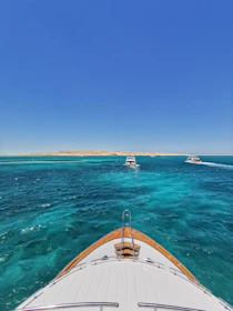 Morning view of the boat cruising through turquoise waters with islands in background.