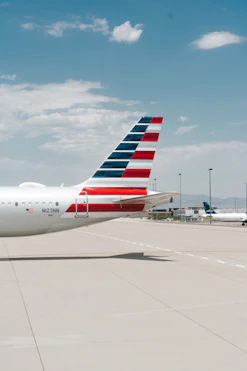 white and red passenger plane on airport during daytime