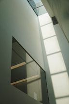 Minimalist architectural studio workspace with clean lines and soft green accents.