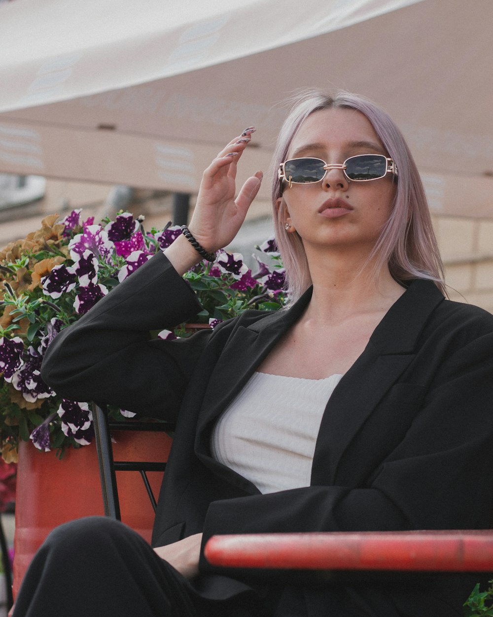 woman in black blazer and white shirt wearing sunglasses