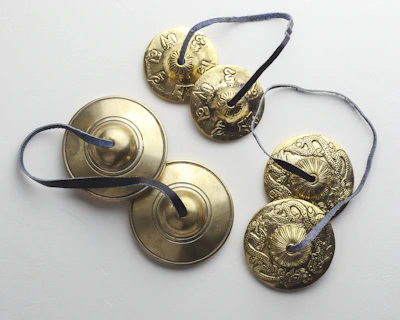 A collection of cymbals arranged neatly on a table.