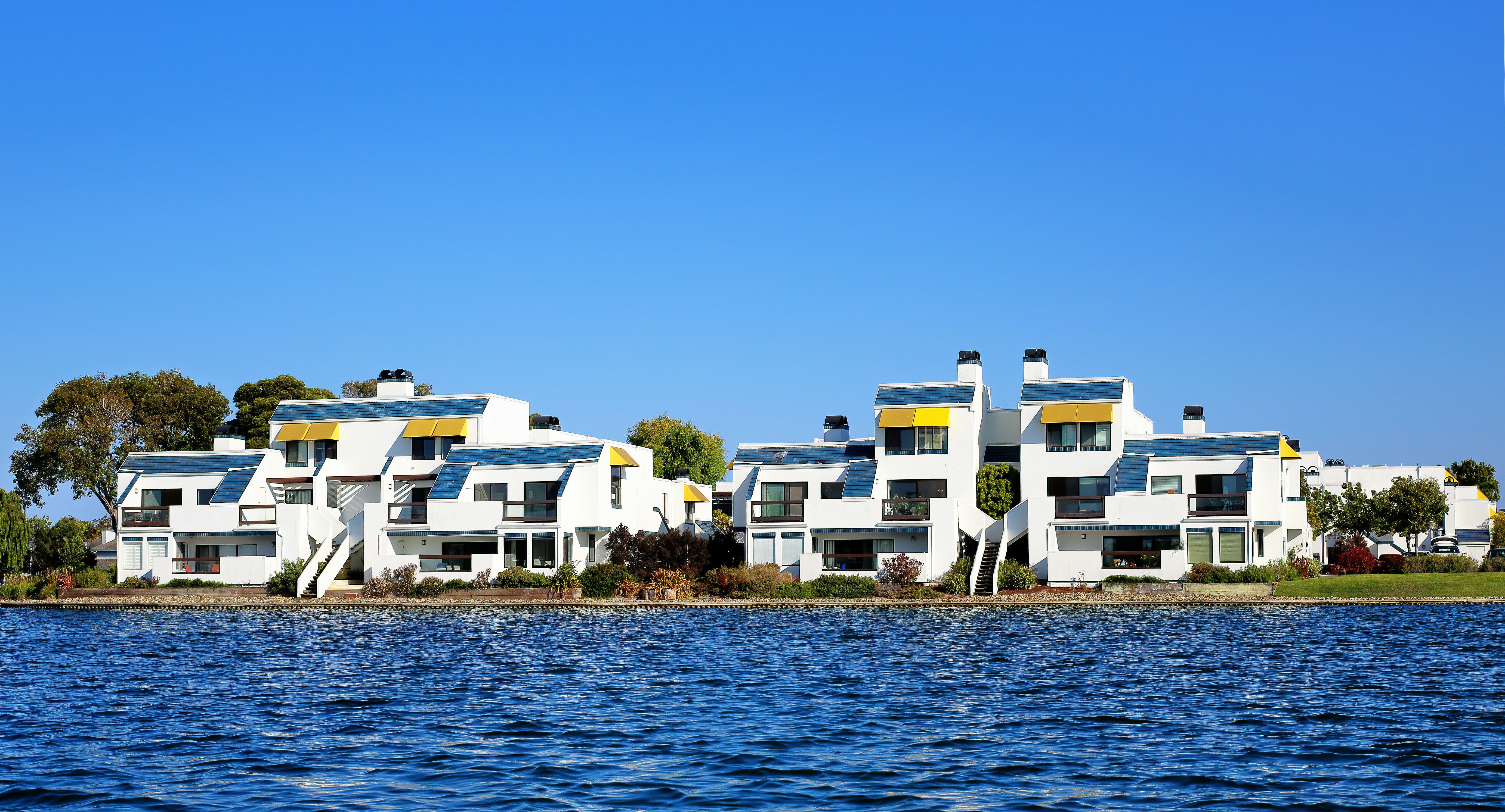 white concrete building near body of water during daytime, Foster City living