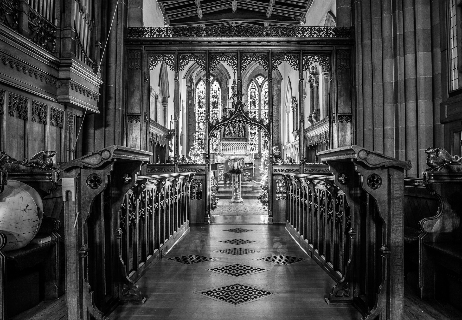 grayscale photo of people walking inside building