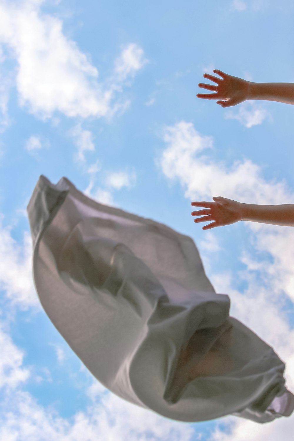 persons hand on white textile