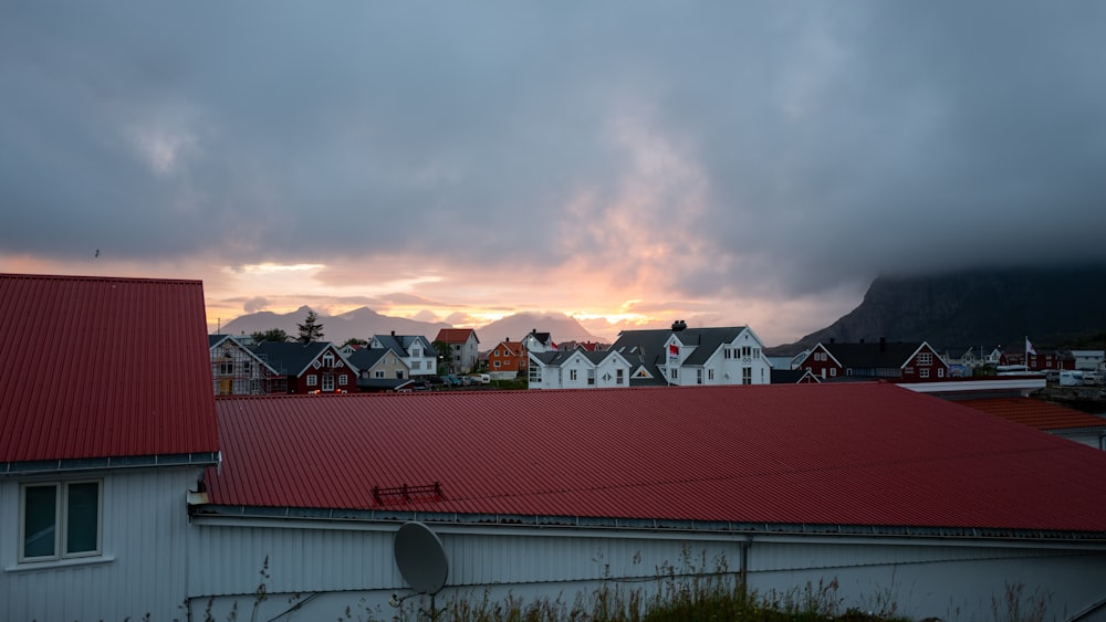 white and red house under cloudy sky during daytime