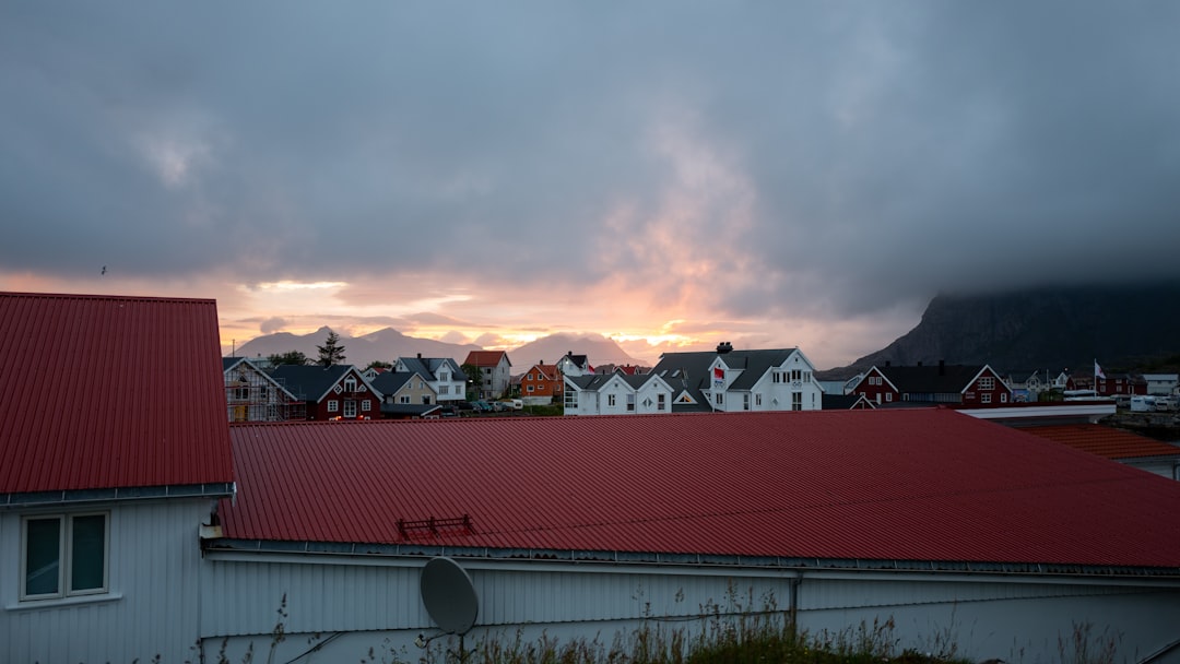 white and red house under cloudy sky during daytime