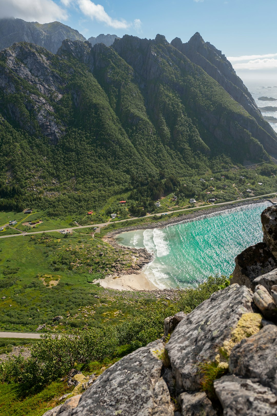 green mountains beside body of water during daytime