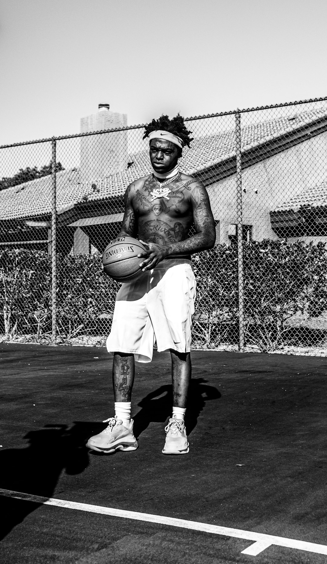 man in white shorts holding basketball