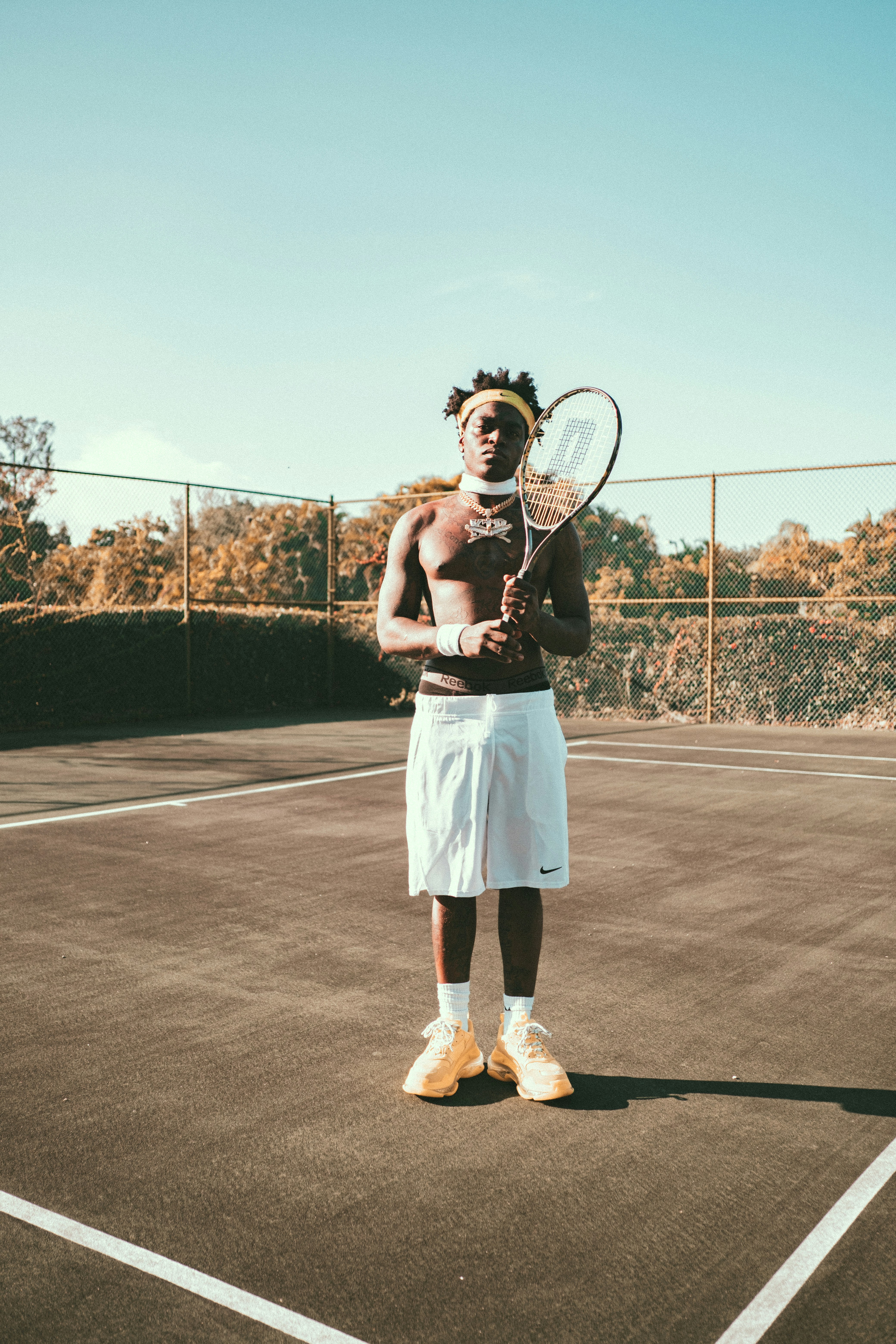 woman in white skirt holding tennis racket