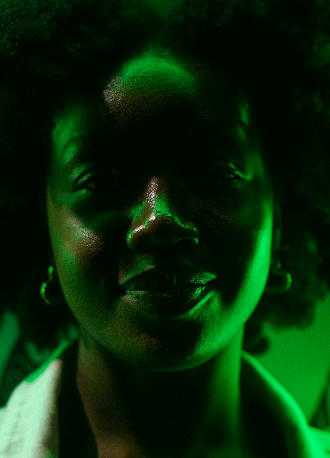 woman in green lipstick and white shirt