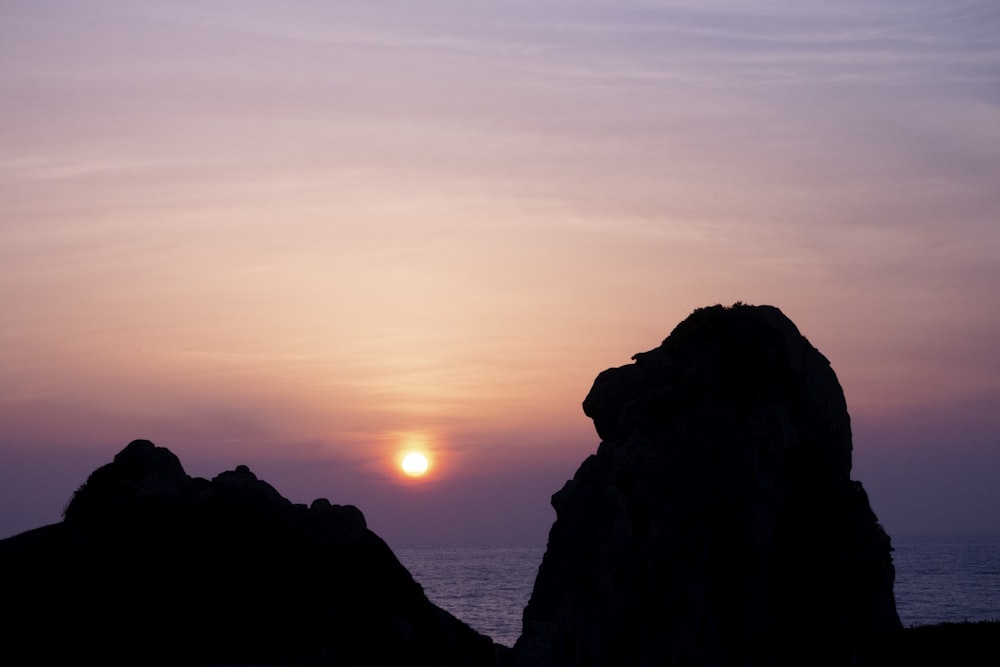 silhouette of rock formation during sunset