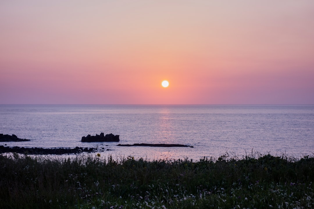 body of water during sunset