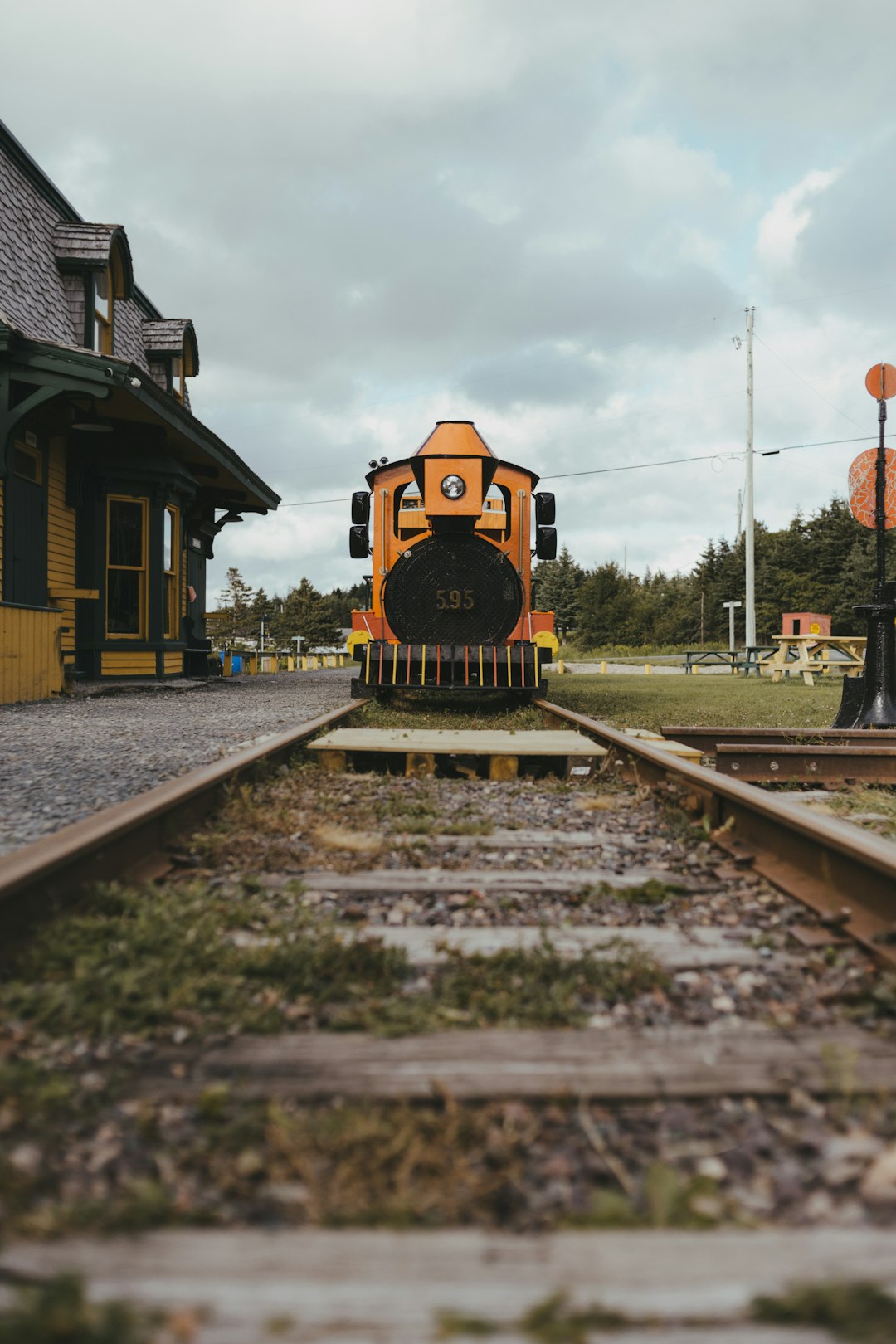 yellow and black train on rail tracks during daytime