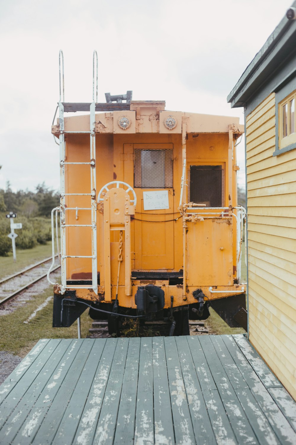 yellow train on rail tracks during daytime