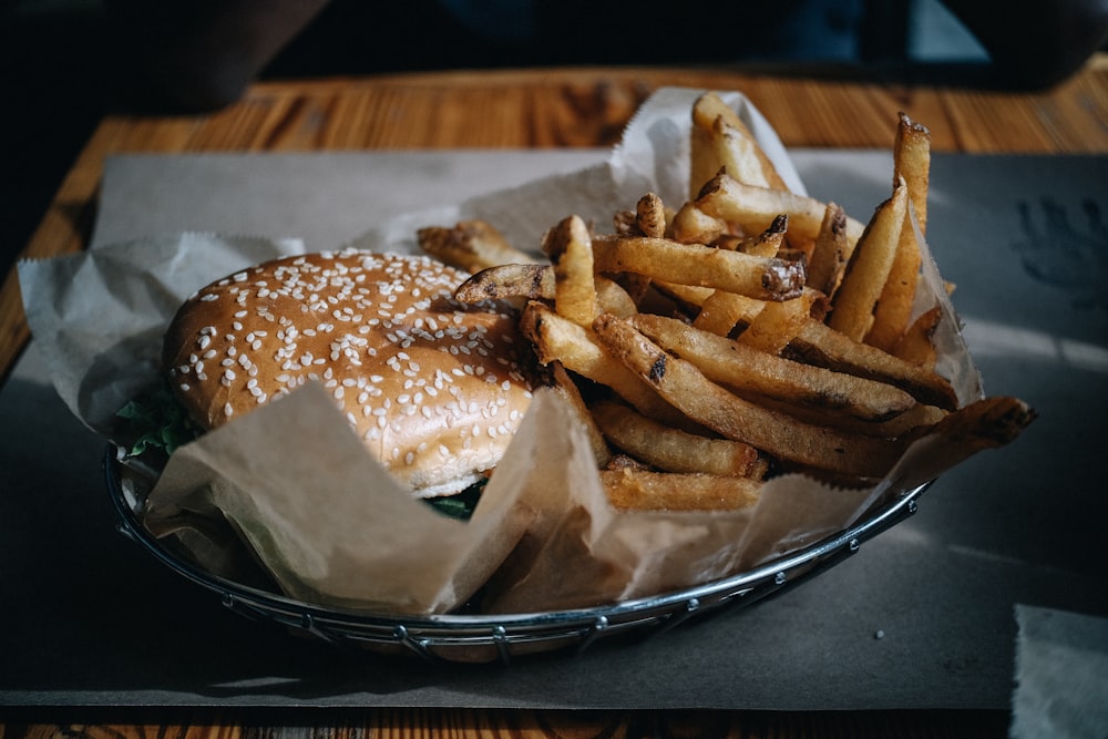 burger with fries on stainless steel round plate