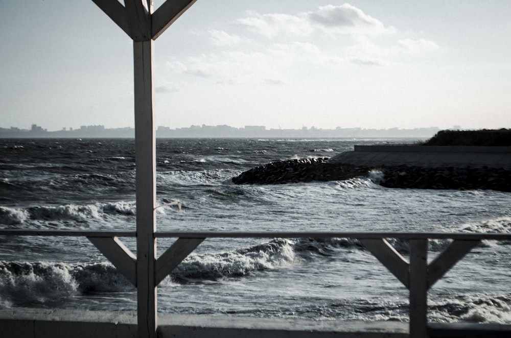 brown wooden frame near sea during daytime