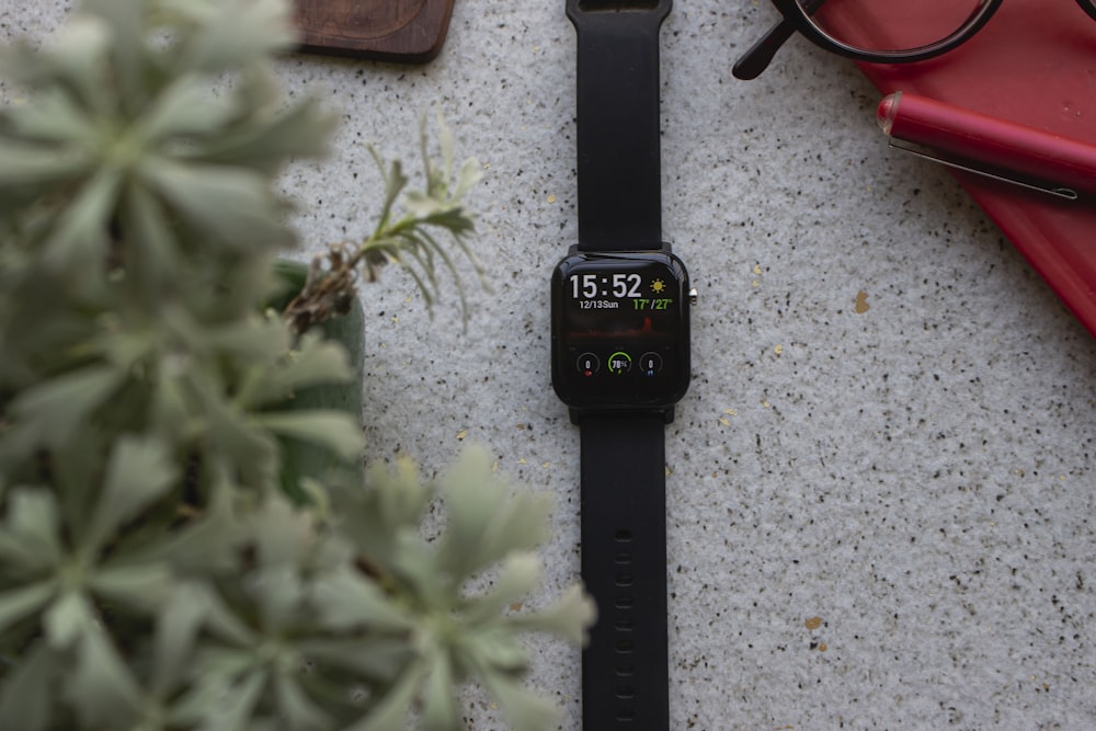 black apple watch with black sport band