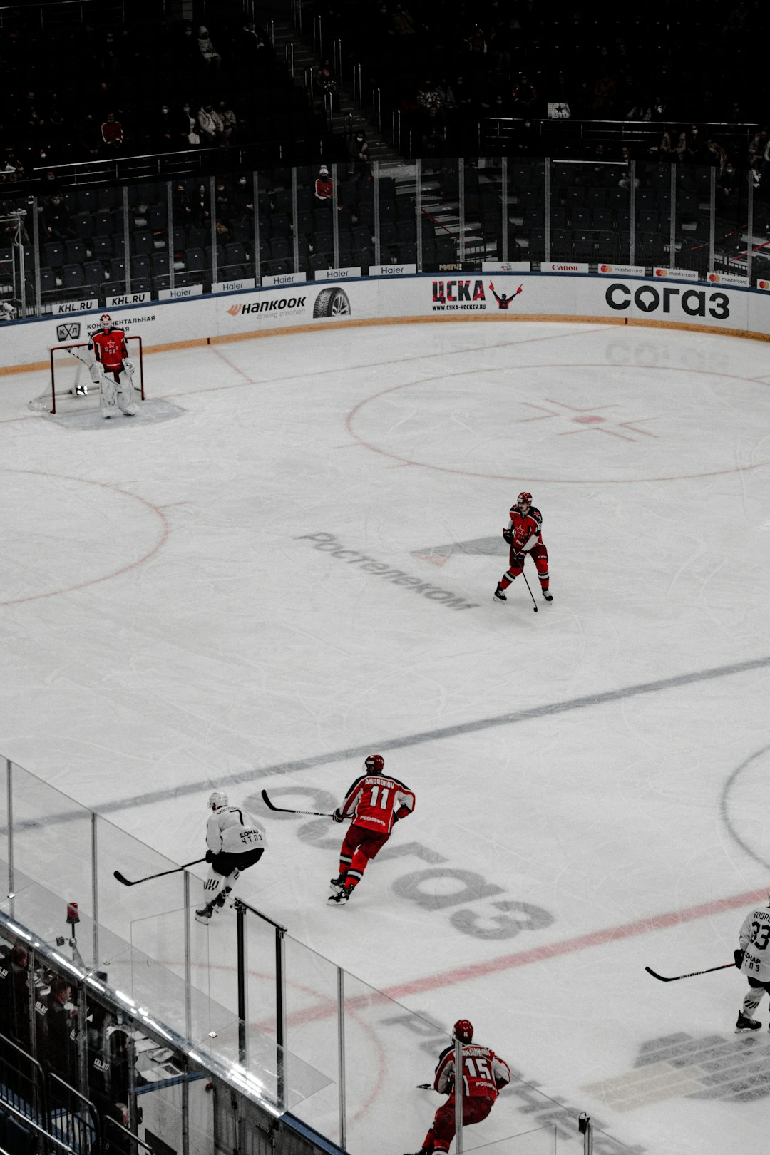 people playing ice hockey on ice field