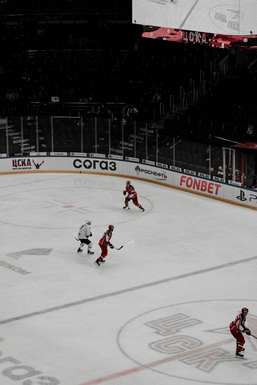 man in red and white ice hockey jersey playing hockey