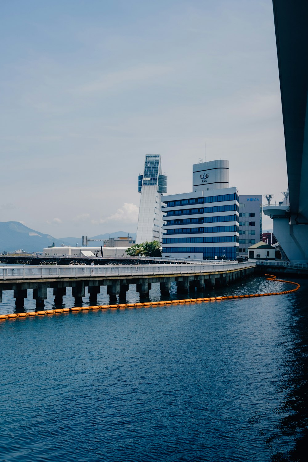 white and black concrete bridge over body of water during daytime