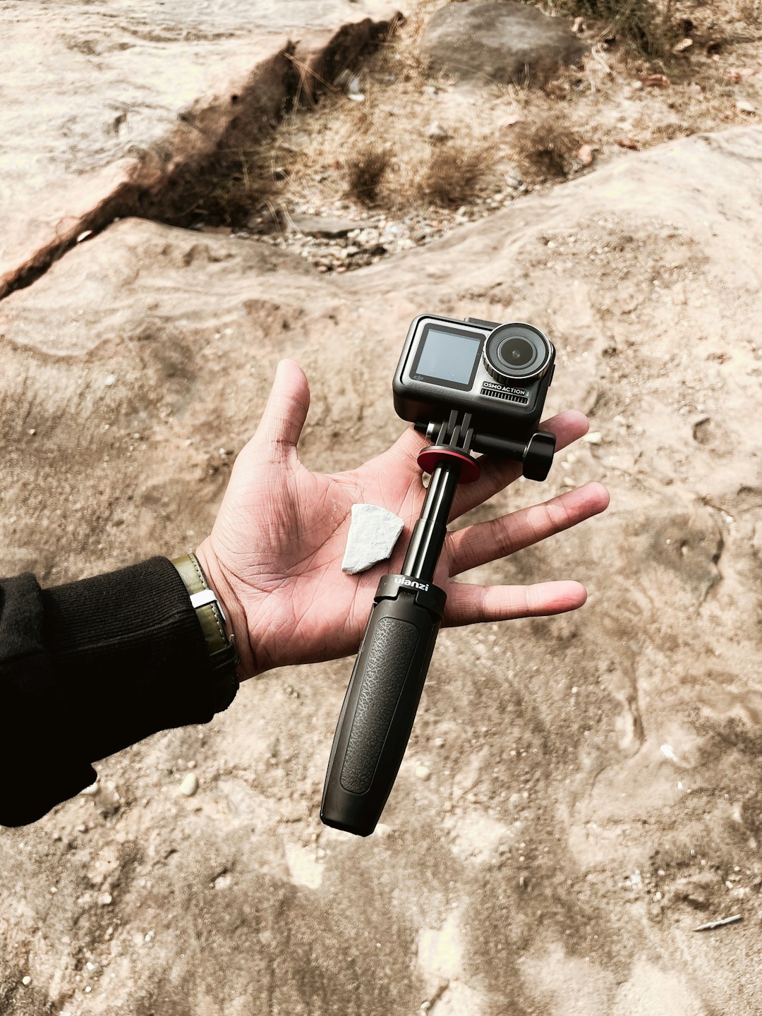 person holding black and silver camera