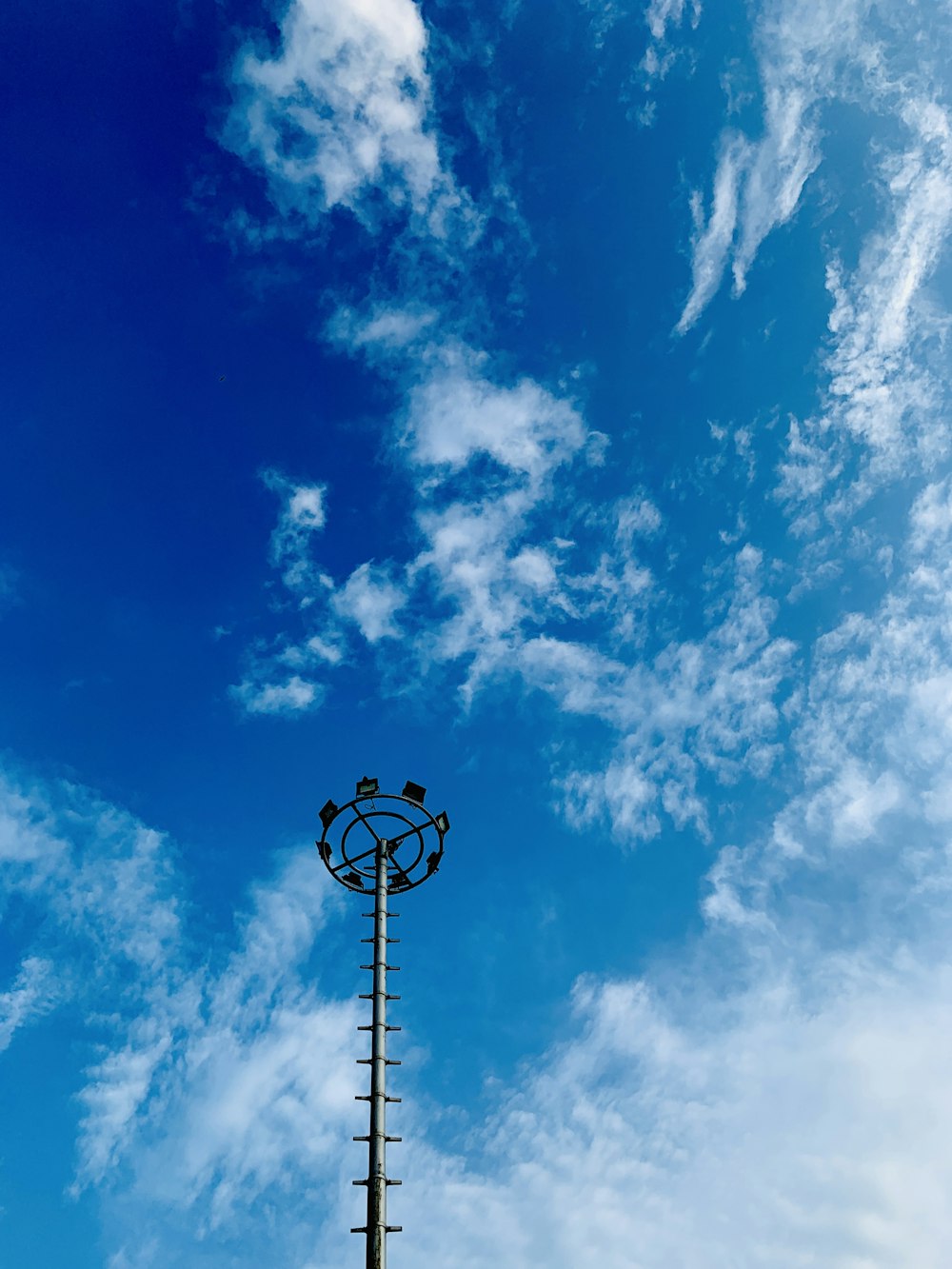 black street light under blue sky and white clouds during daytime