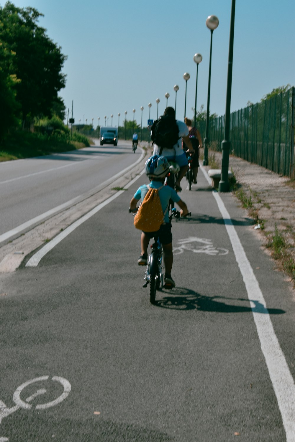 man in black jacket riding bicycle on road during daytime