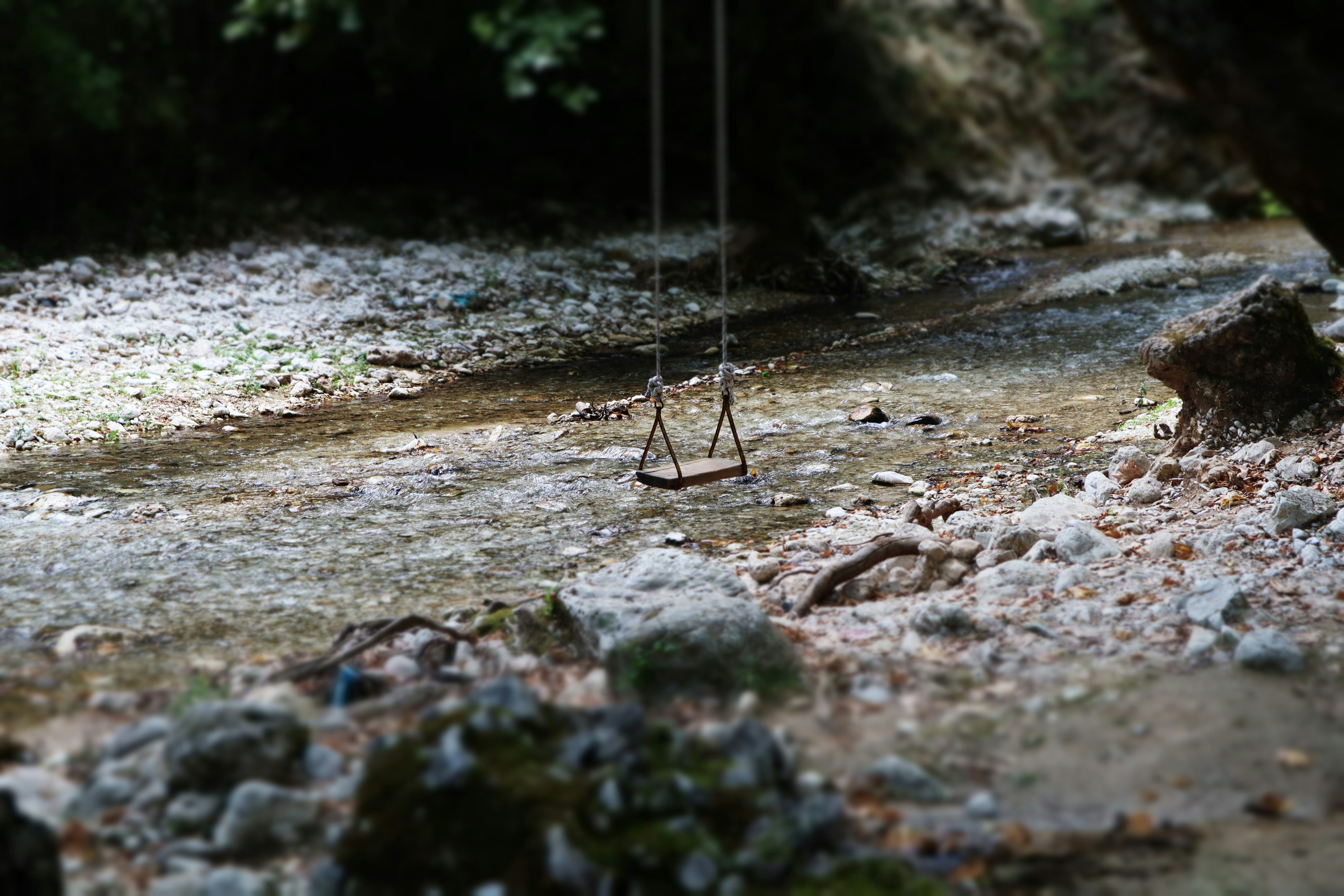 black metal swing on brown soil