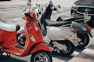 red and white motor scooter