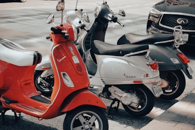 red and white motor scooter