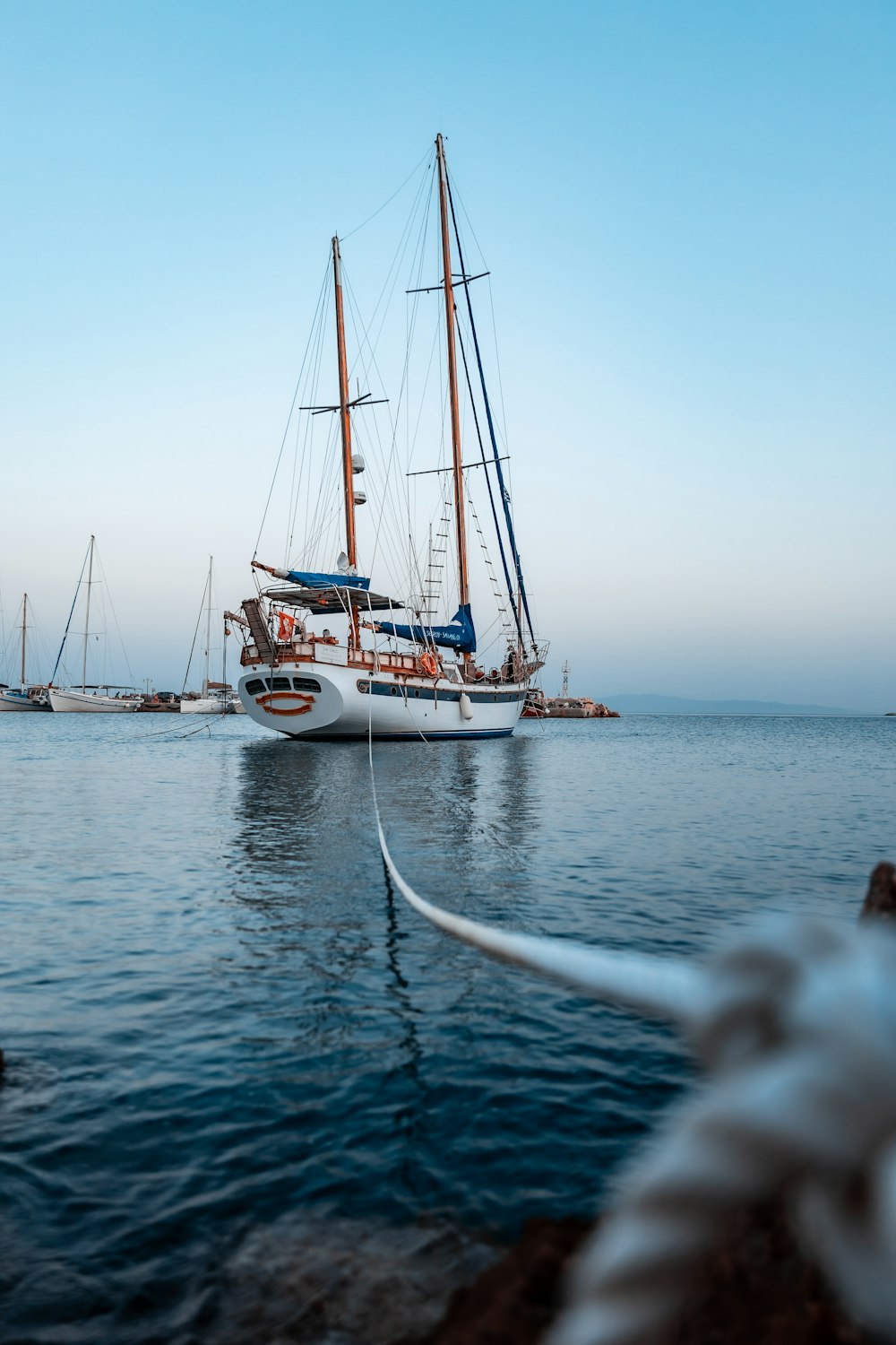 white boat on sea under blue sky during daytime