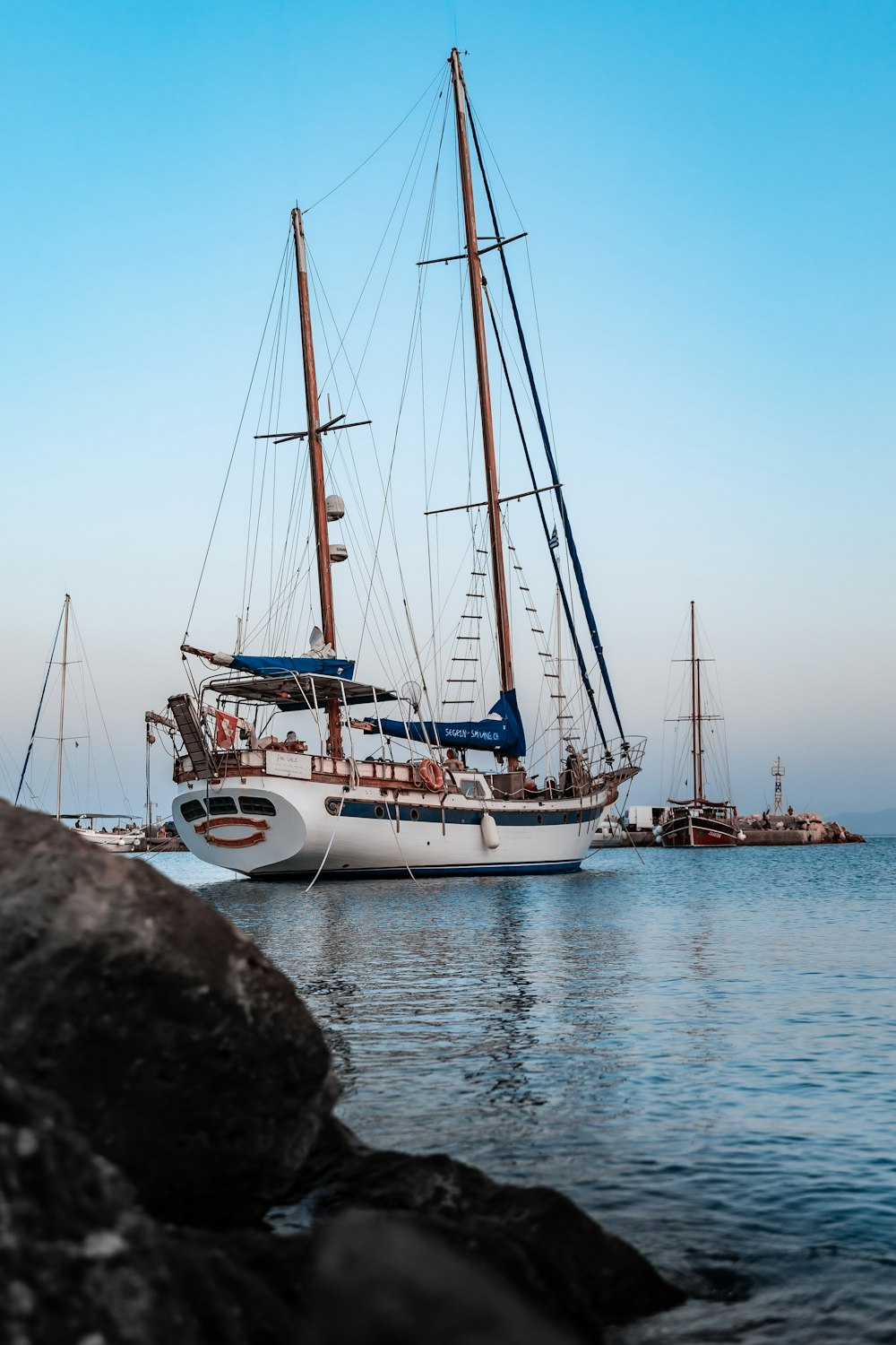 white and blue boat on sea during daytime