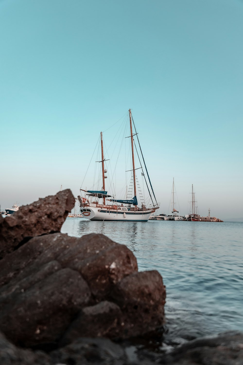 white and blue boat on sea during daytime