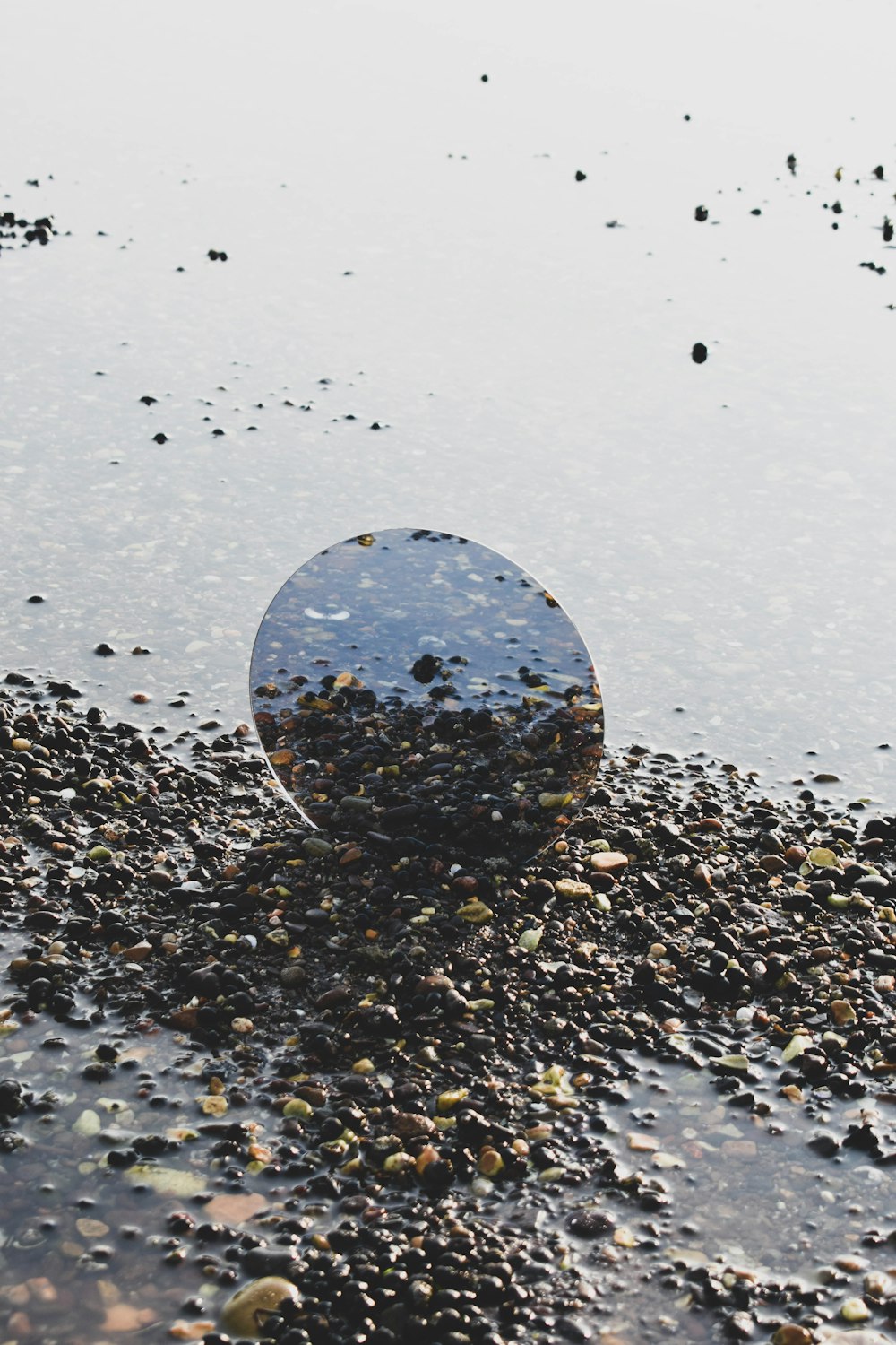 a round object sitting on top of a puddle of water