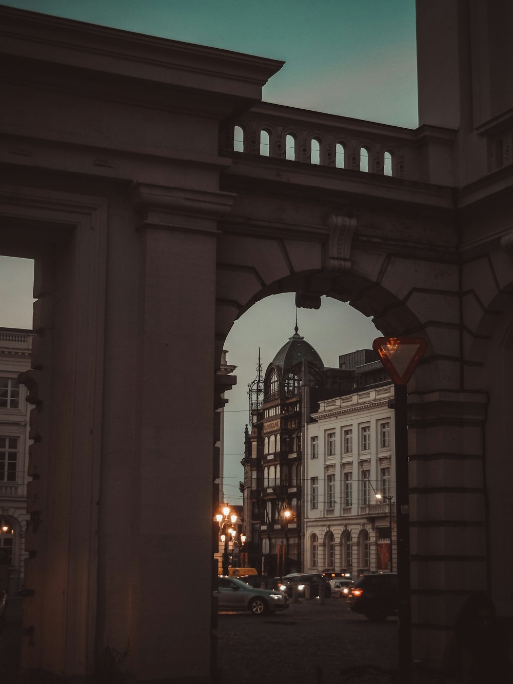 people walking on sidewalk near building during night time