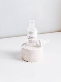 white plastic bottle on white table