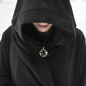 man in black hoodie standing on snow covered ground during daytime