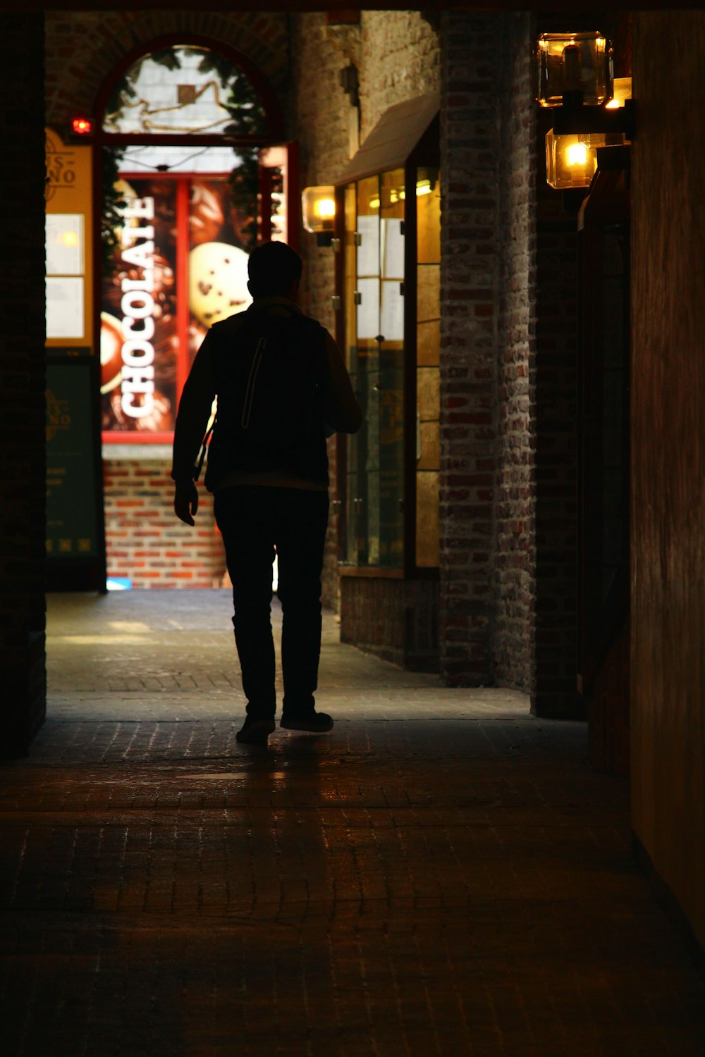 man in black hoodie standing on hallway