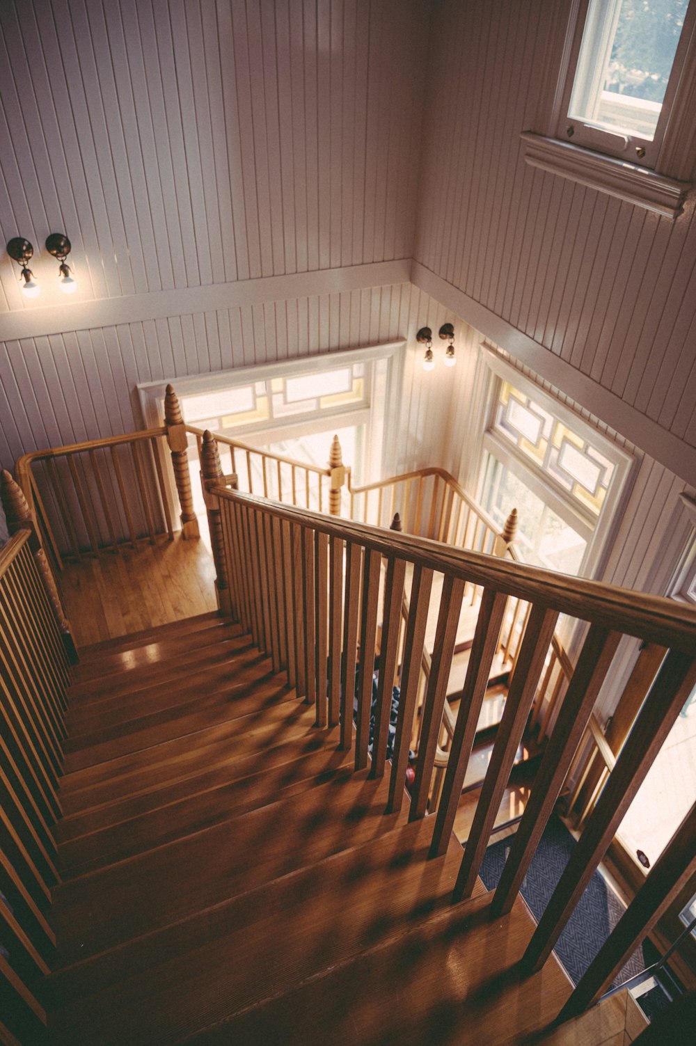 brown wooden staircase in white room