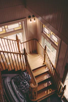 Workers carefully restoring an old wooden staircase with natural light.