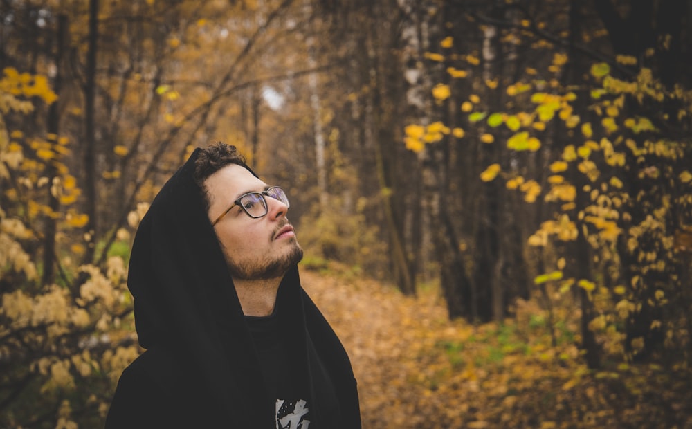 man in black hoodie wearing black framed eyeglasses