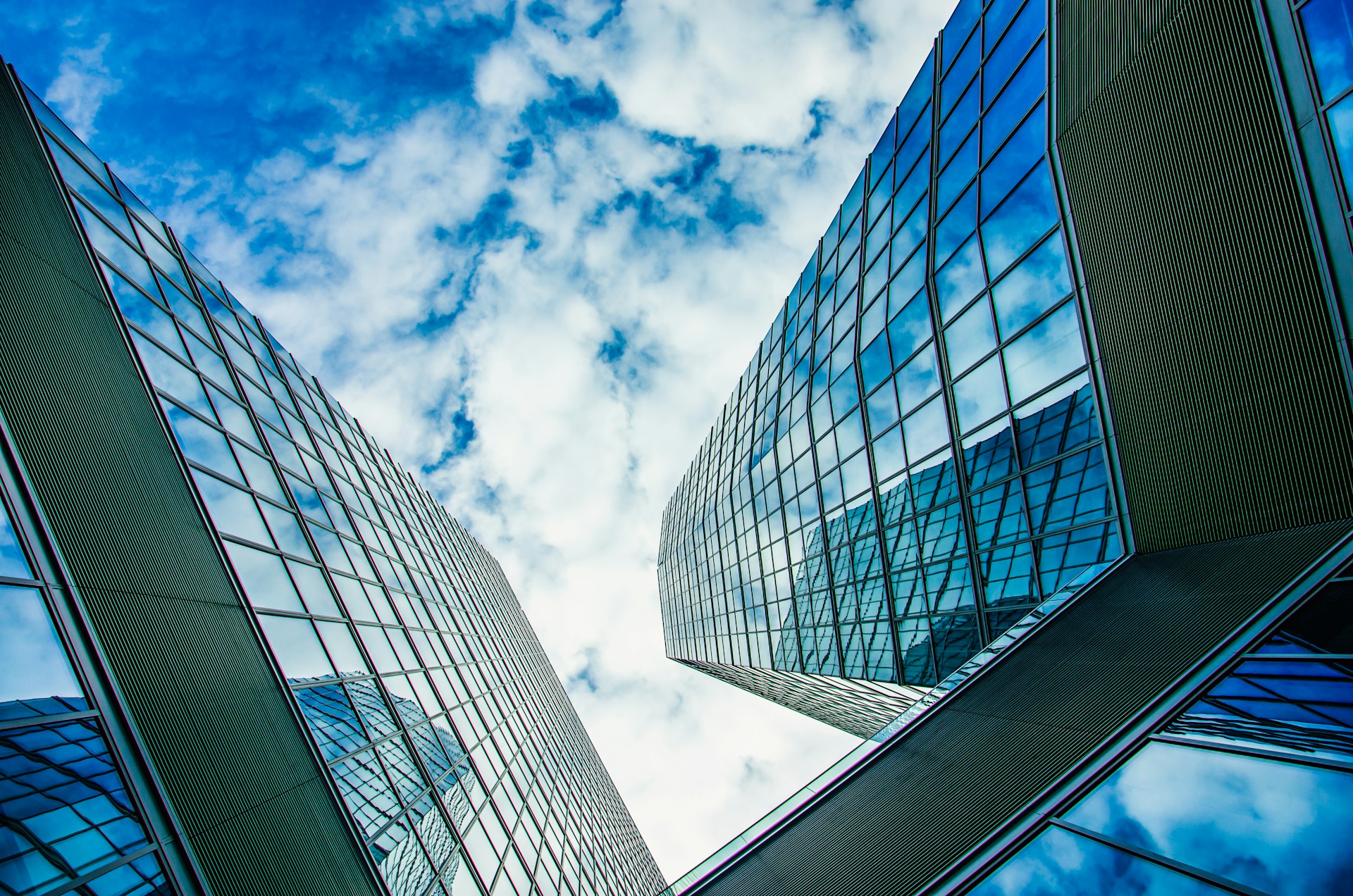 low angle photography of high rise building under blue sky during daytime